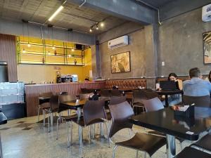 a restaurant with people sitting at tables in a room at Smart Malls Flats in Belém