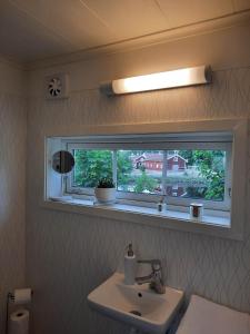 a bathroom with a sink and a window at The old henhouse in Tenhult +60 photos