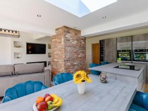 a kitchen and living room with a table with fruit on it at Sea Breezes in Anderby