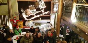 a group of people sitting at a table in a restaurant at Eventhotel Ö - Cappuccino in Geiselwind