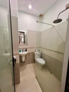 a bathroom with a toilet and a sink at Homestay COAST HOUSE in Da Nang