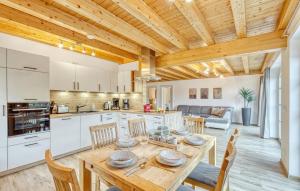 a kitchen and dining room with a wooden ceiling at Nice Apartment In Südharz With Sauna in Stolberg i. Harz
