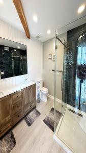 a bathroom with a glass shower and a toilet at 5 Brs, Hot Tub Roof Top, 2Nd Off The Ocean in Loveladies