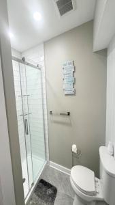 a bathroom with a shower stall and a toilet at 5 Brs, Hot Tub Roof Top, 2Nd Off The Ocean in Loveladies +32 photos