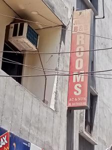 a sign on the side of a building with a window at Jindal homestay in Amritsar