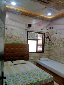 a bedroom with two beds and a window at Jindal homestay in Amritsar
