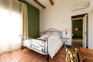 a bedroom with a bed and a green wall at Relais Regina Giovanna in Sorrento