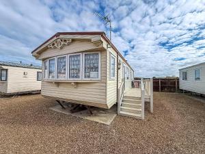 a tiny house sitting on top of a gravel lot at Great 6 Berth Caravan, Perfect For A Beach Holiday In Hunstanton Ref 13007L in Hunstanton