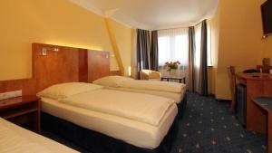 Postel nebo postele na pokoji v ubytování Aparthotel Astro - Nichtraucherhotel