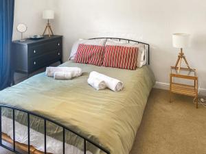 a bedroom with a bed with two pillows on it at Nautilus in St Ives