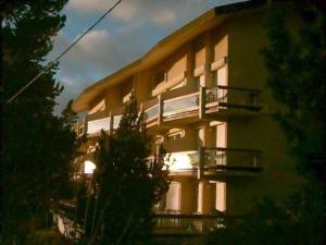a building with a balcony with a train on it at Studio Cabine Confortable - Proche Centre avec Parking - FR-1-580-31 in Font Romeu Odeillo Via +2 photos