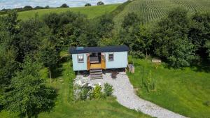 an aerial view of a tiny house in a field at Da Vinci's Den in North Tawton