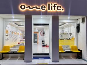 清迈One life Hostel的一家橱窗里摆放着黄色椅子的“一生一世”商店