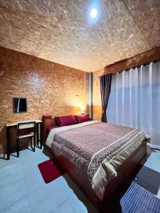 a bedroom with a large bed and a desk at Pharit guesthouse in Pai +22 photos