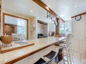 a kitchen with a counter and a dining room at Rectory Cottage in Dibden +15 photos