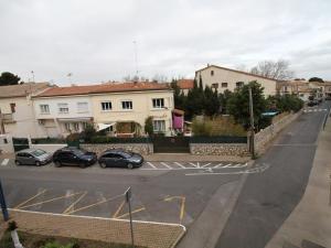 a street with cars parked in front of buildings at Appartement T2 avec Terrasse, proche Thermes, garage et Wifi - Balaruc-les-Bains - FR-1-553-182 in Balaruc-les-Bains