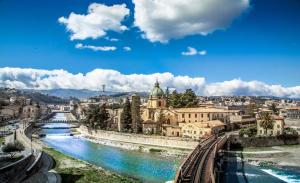 a view of a city with a river and buildings at IELLE Suite Brutia in Cosenza