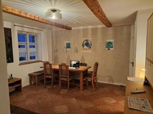 a dining room with a wooden table and chairs at Bierfrauhäusl in Antdorf
