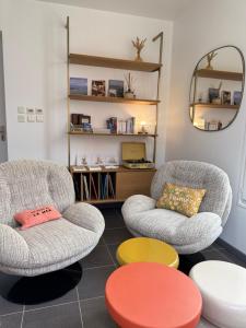 a living room with two chairs and a table at Billie Blue in Ault