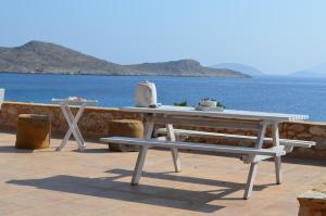 a white picnic table with a view of the ocean at Villa Blu Majestic beach villa in Halki