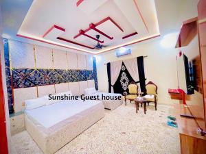 a bedroom with a bed and a guest house at Sunshine Guest House in Dargai