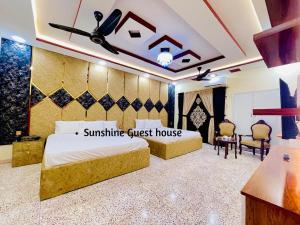 a bedroom with a king sized bed and a guest house at Sunshine Guest House in Dargai