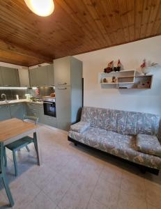 a living room with a couch and a table at Le 4 oche in Bastia +4 photos