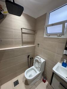 a bathroom with a toilet and a sink at شقق الفندقية للتأجير اليومي in Fulūj Sayghah +12 photos
