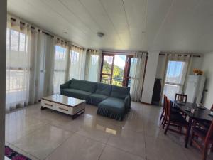 a living room with a couch and a table at Alice Apartment 02 in Nadi