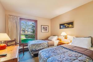 a hotel room with two beds and a window at Trail Creek 16 in Killington Village +15 photos