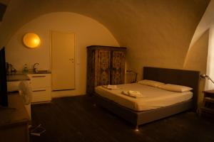 a small bedroom with a bed and a sink at Residence Fink Central Apartments in Bolzano