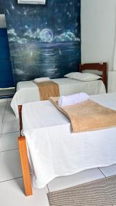 菲格雷多总统镇Abraço Verde Complexo Turístico的房间里有三张床，墙上有一幅画