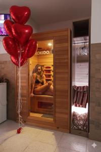 a bunch of red heart balloons in a store at "Il Quercione" Room With SpA in Lama Di Peligni