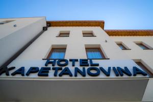 a blue and white building with a sign on the front of it at Hotel Kapetanovina in Mostar