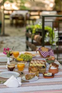 a table topped with plates of food and drinks at Mountain Hotels "Achais" in Planitéron +19 photos