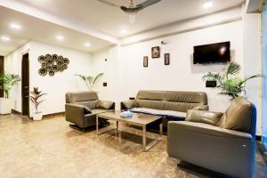 a living room with two couches and a table at Hotel Grand Lowsan in New Delhi