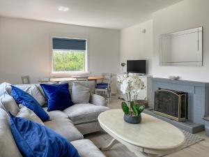 a living room with a couch and a table at Acreknowe Cottage in Hawick