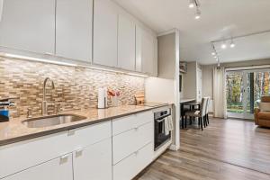 a kitchen with white cabinets and a dining room at Edgemont C1 in Killington Village