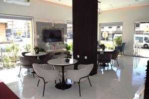 a restaurant with two tables and chairs and windows at المواسم in Tabuk