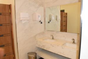 a bathroom with two sinks and a large mirror at المواسم in Tabuk +37 photos
