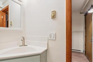 a bathroom with a sink and a mirror at Whiffletree H1 in Killington Village +19 photos