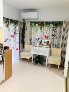 a dining room with a table and two chairs at Ikebukuro-hostel池袋中川301&501 in Tokyo