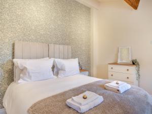 a bedroom with a bed with towels on it at Eaton Barn - Uk45499 in Great Budworth +18 photos