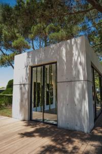 a concrete house with large sliding glass doors at Kemay Hotel Boutique in José Ignacio +9 photos