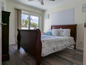 a bedroom with a bed and a large window at Oceanfront 2br2b, Ocean Views, Heated Pool, Spa in Cape Canaveral +89 photos