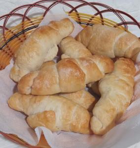 a basket of buns sitting on a table at Mervins & Indus Residence in Colombo