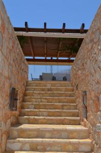 a set of stairs in a stone wall at Villa Blu Majestic beach villa in Halki