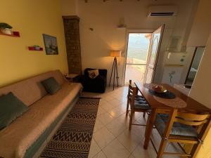 a living room with a couch and a table at Eva's Apartments in Karlovasi