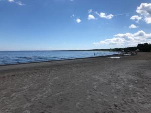 a sandy beach with the ocean in the background at Sea side home in Jūrmala