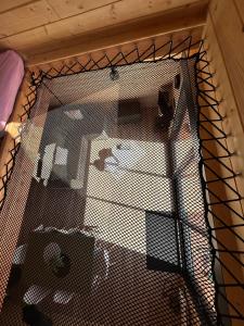 a cage in a room with a bed at L Atypique in Saint-Éloi +20 photos